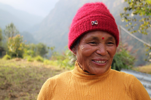 Photo of Riki Maya smiling in front of her field