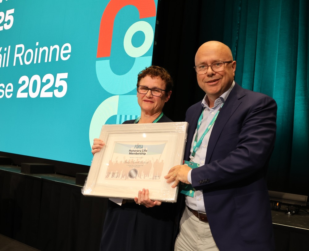 Photo of Betty Tyrell Collard receiving distinguished service award from Fórsa General Secretary Kevin Callinan