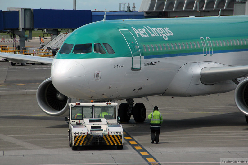 Source: Can Pac Swire[CC BY-NC 2.0], via Flickr - Aer Lingus plane parked at airport gate.